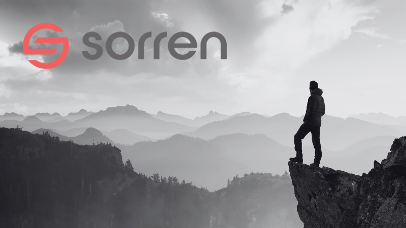 A silhouetted person standing on a cliff with mountains in the background, in black and white, with Sorren logo.